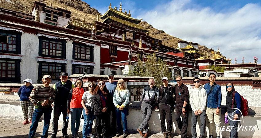 A cheerful group photo with our tour guide Tashi at the Thasilhunpo Monastery
