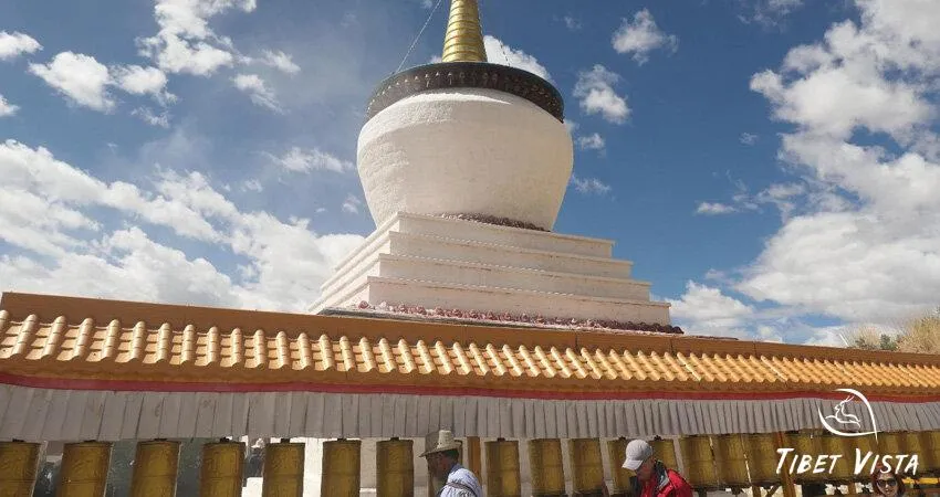 Local Tibetans walk clockwise around the white sutpa for pilgrimage